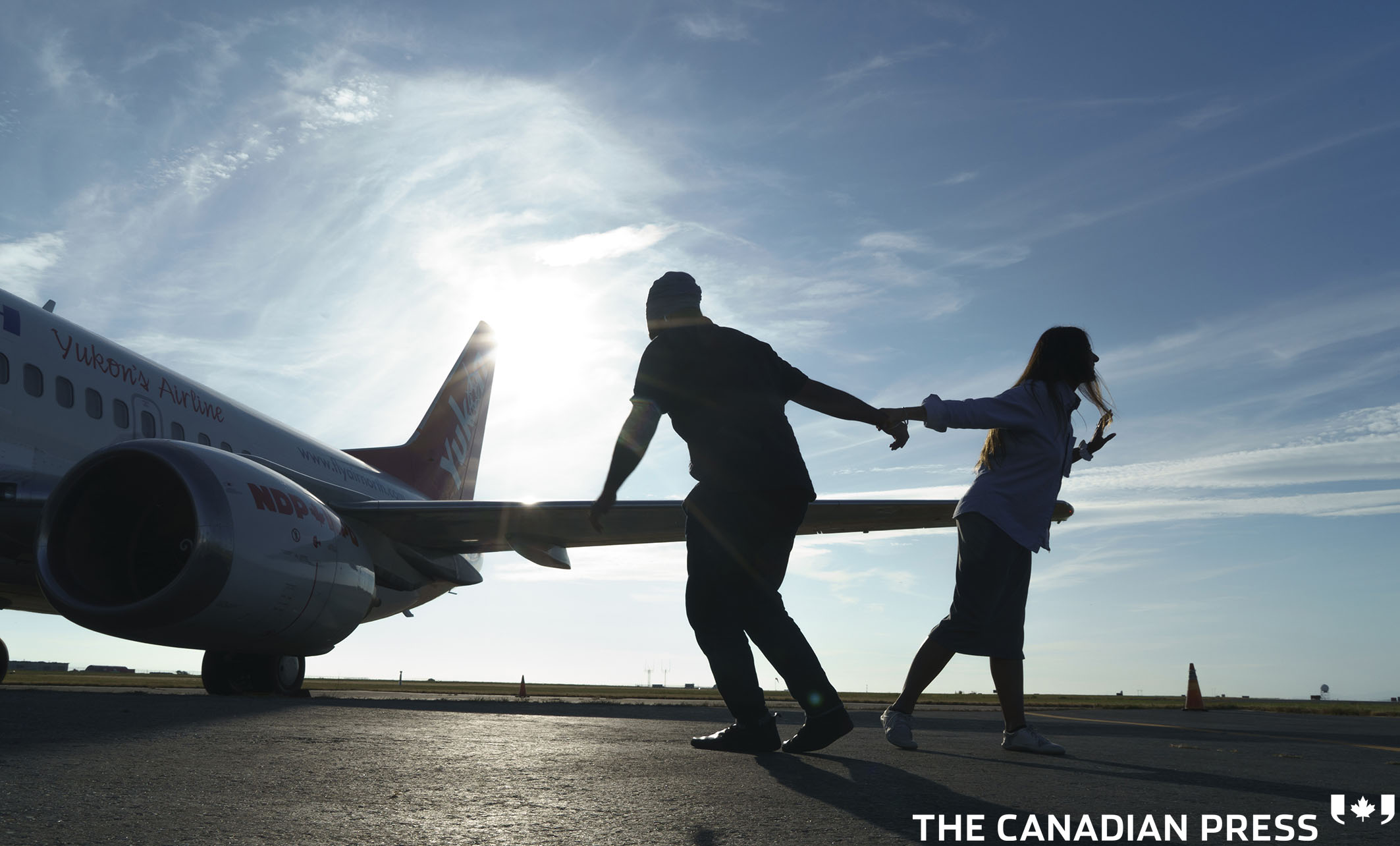 NDP leader Jagmeet Singh and his wife Gurkiran Kaur Sidhu record a tip top dance for Tik Tok by the campaign plane at the airport in Vancouver, on Wednesday, August 18, 2021. THE CANADIAN PRESS/Paul Chiasson
