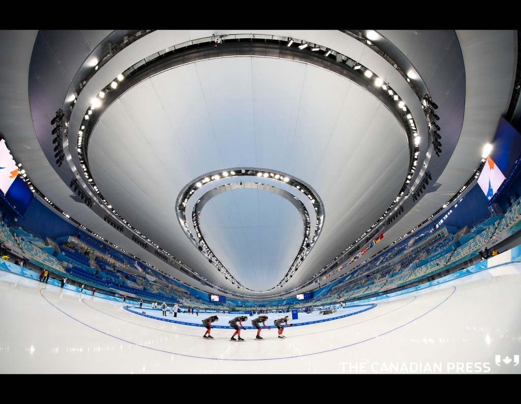 Members of the Canadian speed skating team round the oval during a practice at the 2022 Winter Olympics in Beijing on Wednesday, February 2, 2022. THE CANADIAN PRESS/Paul Chiasson